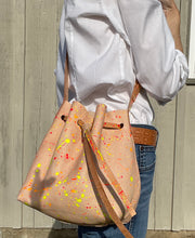 Load image into Gallery viewer, Neon Splatter Veg Tan Leather Drawstring Crossbody Bucket Bag
