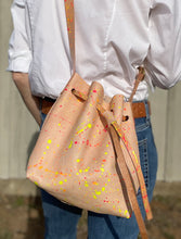 Load image into Gallery viewer, Neon Splatter Veg Tan Leather Drawstring Crossbody Bucket Bag
