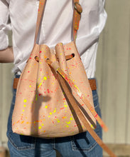 Load image into Gallery viewer, Neon Splatter Veg Tan Leather Drawstring Crossbody Bucket Bag
